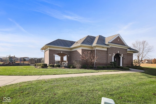 view of front of house with a playground and a front yard