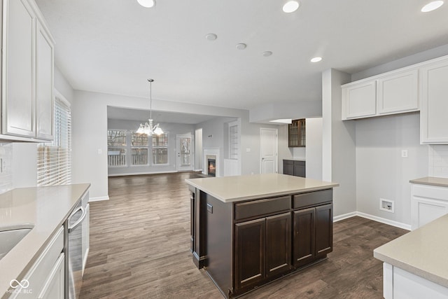 kitchen with decorative light fixtures, white cabinetry, and stainless steel dishwasher