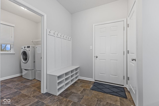 laundry room with washing machine and clothes dryer and a textured ceiling