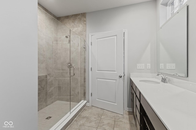 bathroom featuring tile patterned flooring, vanity, and a shower with shower door