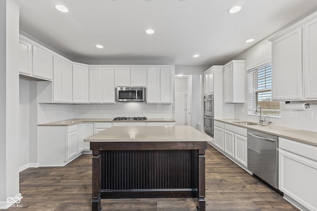 kitchen with white cabinets, stainless steel appliances, dark wood-type flooring, and sink