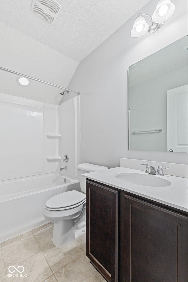 full bathroom featuring vaulted ceiling, a textured ceiling, toilet, vanity, and bathtub / shower combination