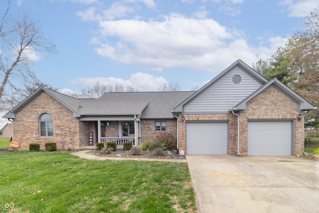 view of front facade featuring covered porch, a garage, and a front lawn