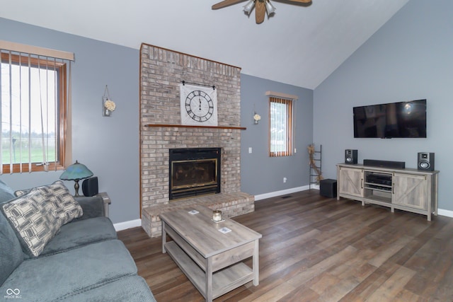 living room with ceiling fan, dark hardwood / wood-style flooring, lofted ceiling, and a fireplace