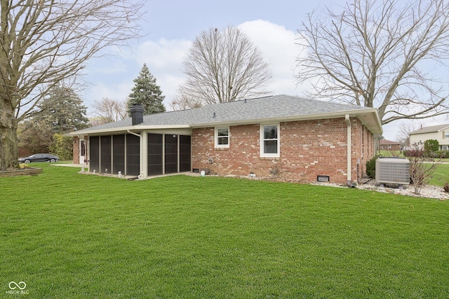 back of house with cooling unit, a sunroom, crawl space, a lawn, and brick siding