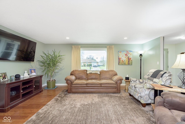 living area featuring recessed lighting, baseboards, and wood finished floors