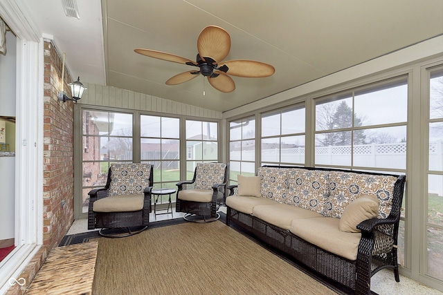 sunroom / solarium featuring visible vents, a ceiling fan, and vaulted ceiling