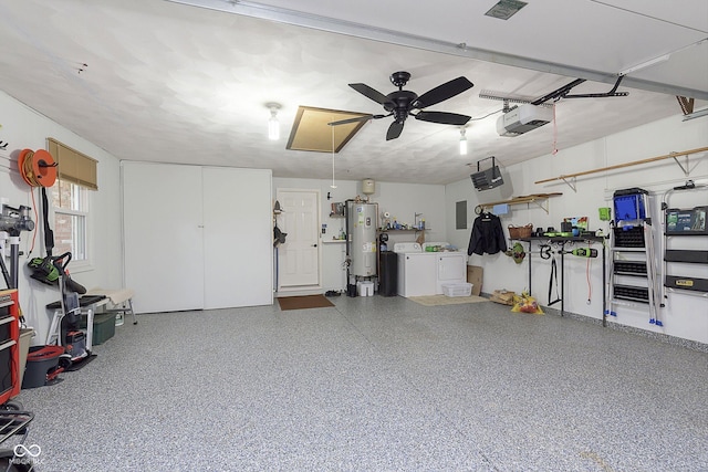 garage with ceiling fan, water heater, electric panel, a garage door opener, and separate washer and dryer