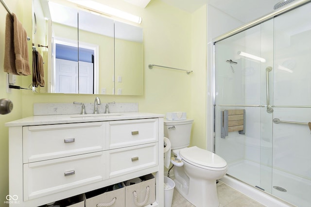 full bathroom featuring tile patterned floors, vanity, toilet, and a shower stall