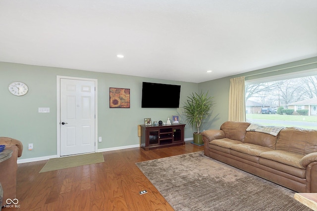 living area with recessed lighting, baseboards, and wood finished floors