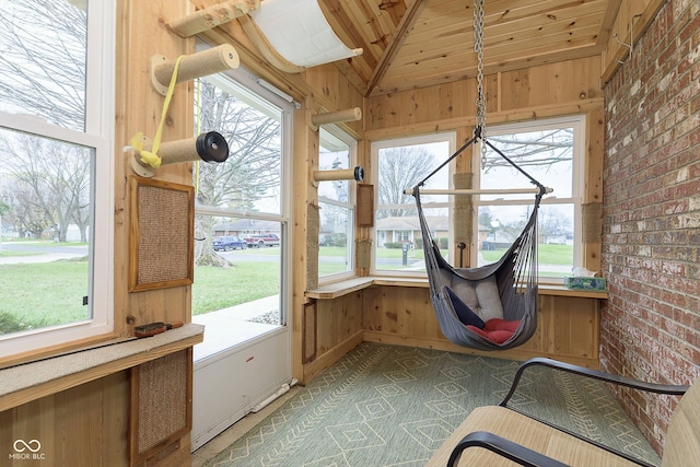 unfurnished sunroom featuring lofted ceiling and wood ceiling