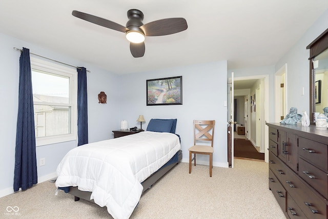 bedroom with baseboards, light colored carpet, and ceiling fan