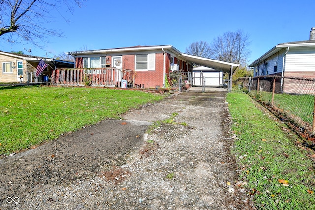 view of front of property with a front lawn and a carport