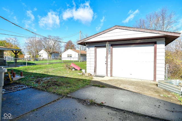 garage featuring a lawn