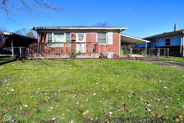 ranch-style house featuring a front lawn and a carport