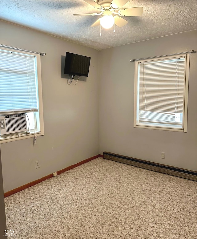 carpeted empty room with a textured ceiling, a baseboard radiator, ceiling fan, and cooling unit