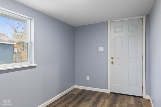 unfurnished room with dark hardwood / wood-style floors and a wealth of natural light