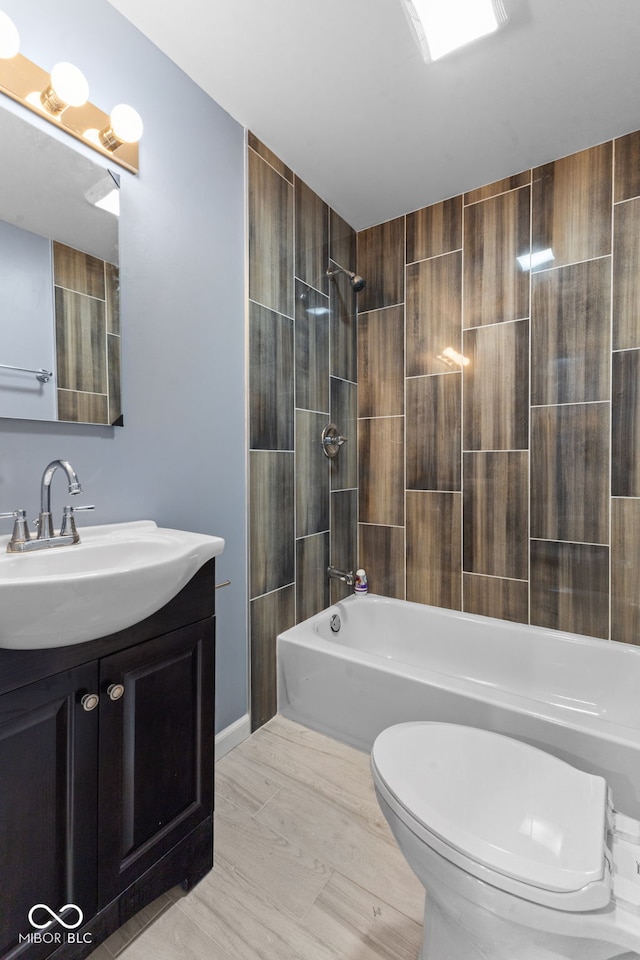 full bathroom with vanity, toilet, and tiled shower / bath