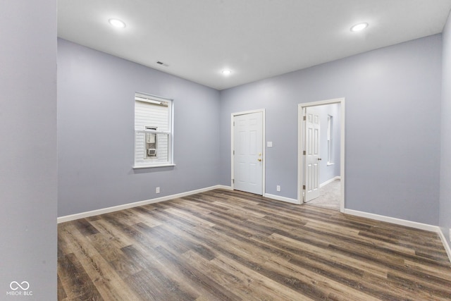 unfurnished room with dark wood-type flooring