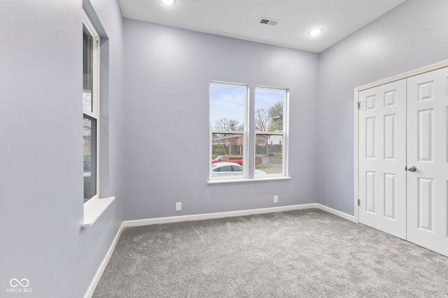 unfurnished bedroom with carpet and a closet