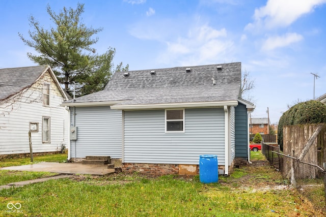 back of house featuring a yard and a patio