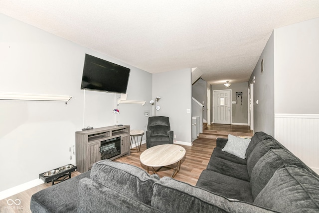 living room featuring hardwood / wood-style flooring and a textured ceiling