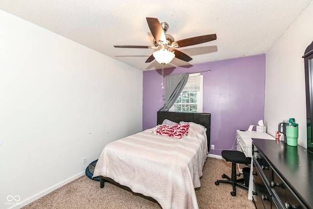 bedroom featuring light carpet, a textured ceiling, and ceiling fan