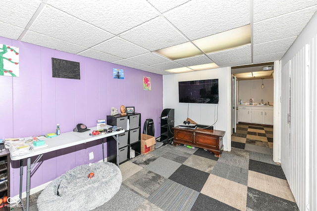 interior space featuring a paneled ceiling and sink