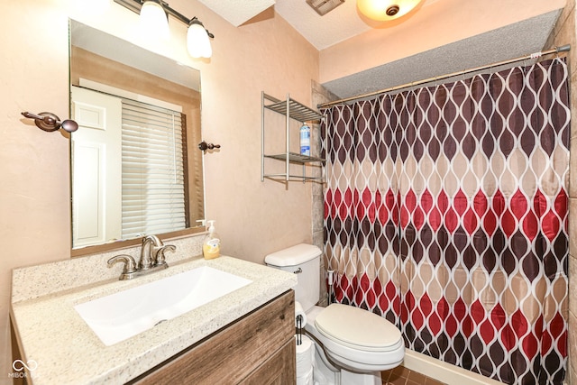 bathroom with a shower with curtain, vanity, a textured ceiling, and toilet