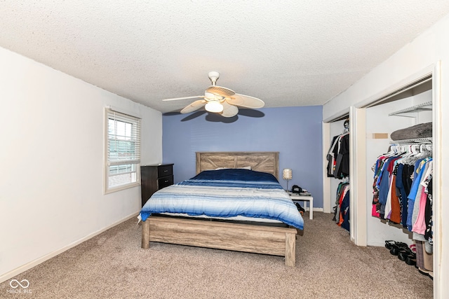 carpeted bedroom featuring a textured ceiling and ceiling fan