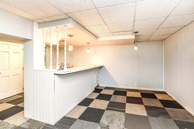 bar with pendant lighting, a paneled ceiling, dark carpet, and sink