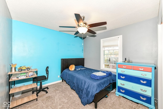 bedroom featuring light carpet, ceiling fan, and a textured ceiling