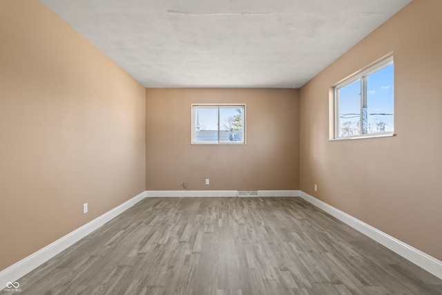 spare room with light hardwood / wood-style flooring