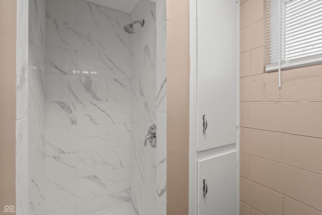 bathroom with a tile shower