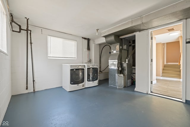 basement featuring independent washer and dryer and heating unit