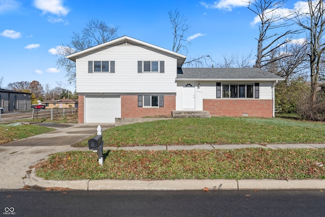 tri-level home with a front yard and a garage