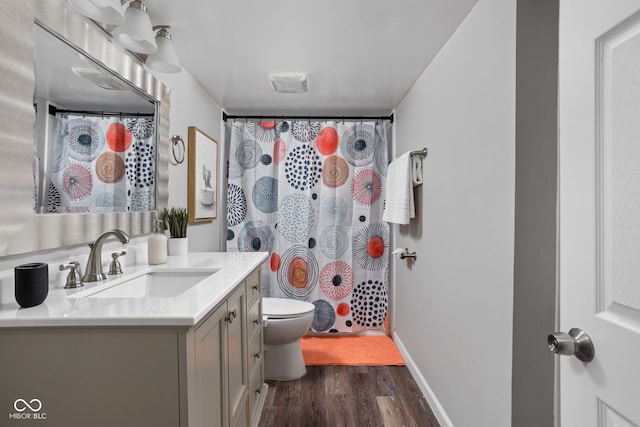 bathroom with hardwood / wood-style floors, vanity, a shower with shower curtain, and toilet