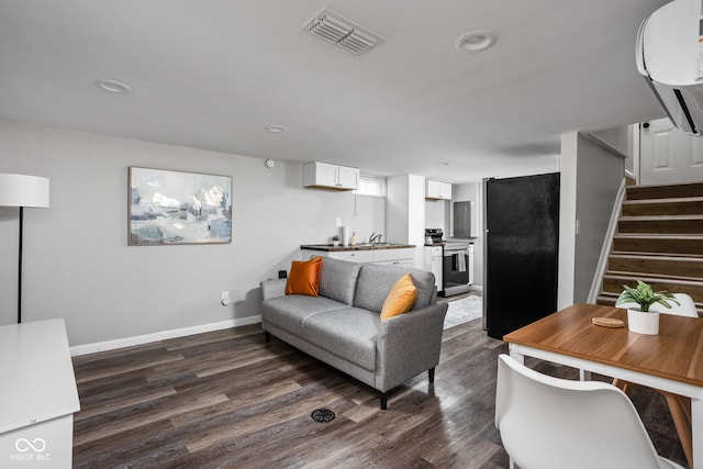 living room with sink and dark wood-type flooring