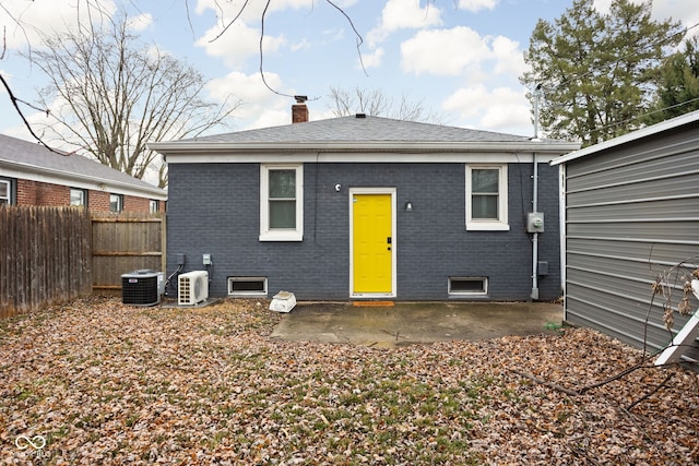 back of property with central AC and a patio area