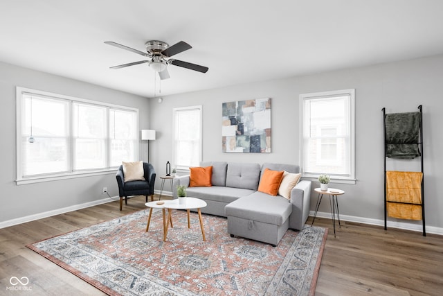 living room with hardwood / wood-style flooring, ceiling fan, and a wealth of natural light