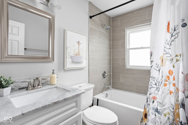 full bathroom with vanity, shower / tub combo, and toilet