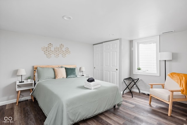 bedroom featuring hardwood / wood-style floors and a closet