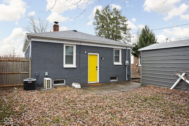 rear view of property featuring a patio area and central AC