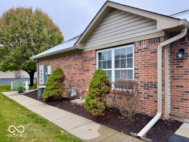 view of side of home featuring central AC unit