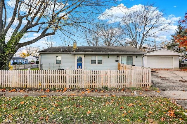 8902 Carla Dr, Indianapolis, IN 46219 - rear view of house with a detached garage, a fenced front yard, and a chimney