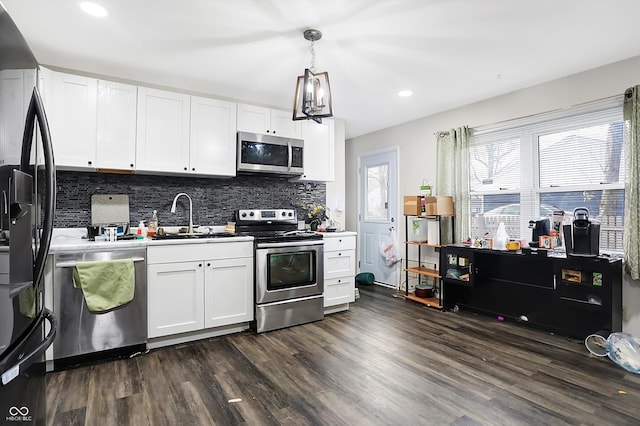 kitchen featuring white cabinets, stainless steel appliances, dark wood-type flooring, and sink