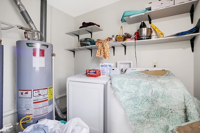 clothes washing area featuring gas water heater and independent washer and dryer