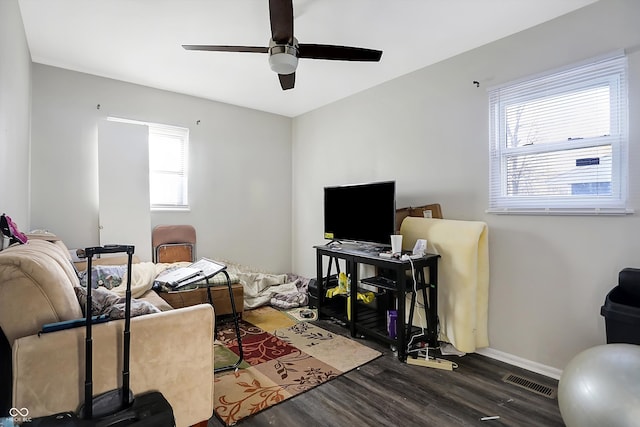 living room with ceiling fan and dark hardwood / wood-style flooring