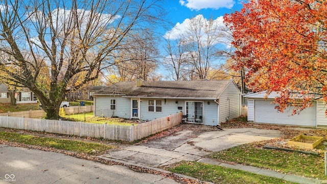 8902 Carla Dr, Indianapolis, IN 46219 - view of front of home with a fenced front yard and a detached garage