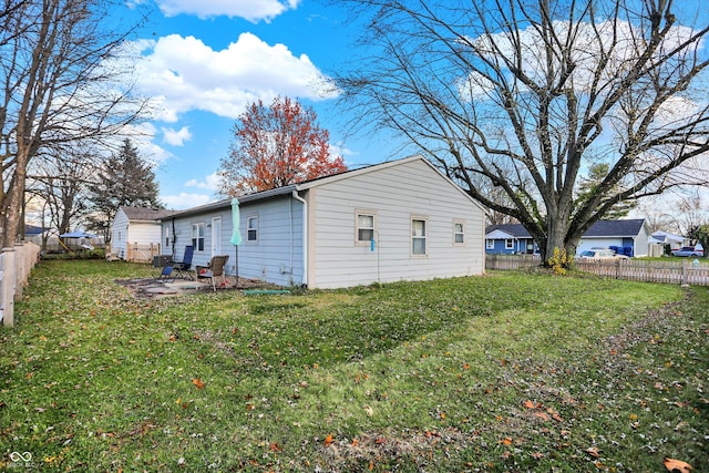 view of home's exterior with a lawn and a patio area